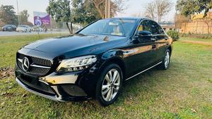 Mercedes-Benz C180 avantgrade-S  package ( twin turbo charged)
Model 2019 ( original facelift)
Registered Islamabad 2020
Shahnawaz import 
Mileage 13000
Brand New condition ( bumper to bumper original & spotless)
Full service history in shahnawaz Lahore. Only one moter oil changed.
Colour Black with beige nappa leather interior.
Top of line specs.
Electric Panoramic sunroof 
Premium entertainment sound system 
Electric power seats 
8 zone climate control air conditioning 
54 colours ambient interior lighting 
Adapted cruise control 
360 degrees cameras
Auto Parktronic access 
Multi drivetonic sensors
Multiple driving selection 
LED adapter headlights 
Apple CarPlay & android apps 
Crome line  packages 
18” alloy wheels 
Privacy glass 
Further information please call & visit Victory Cars jail road Lahore.
National wide delivery available.